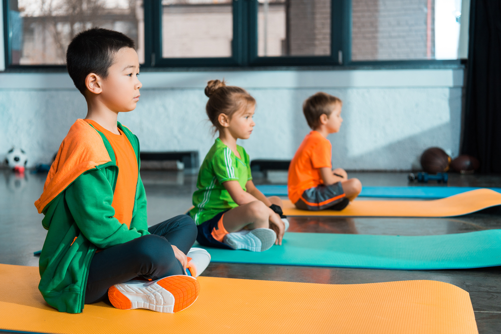 Young children learning meditation for kids