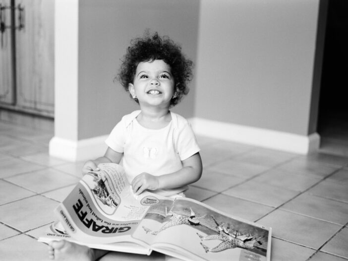 young child reading an oversize book