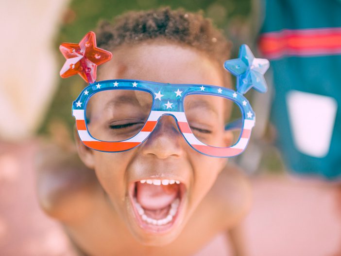 young child with American flag sunglasses for the Fourth of July