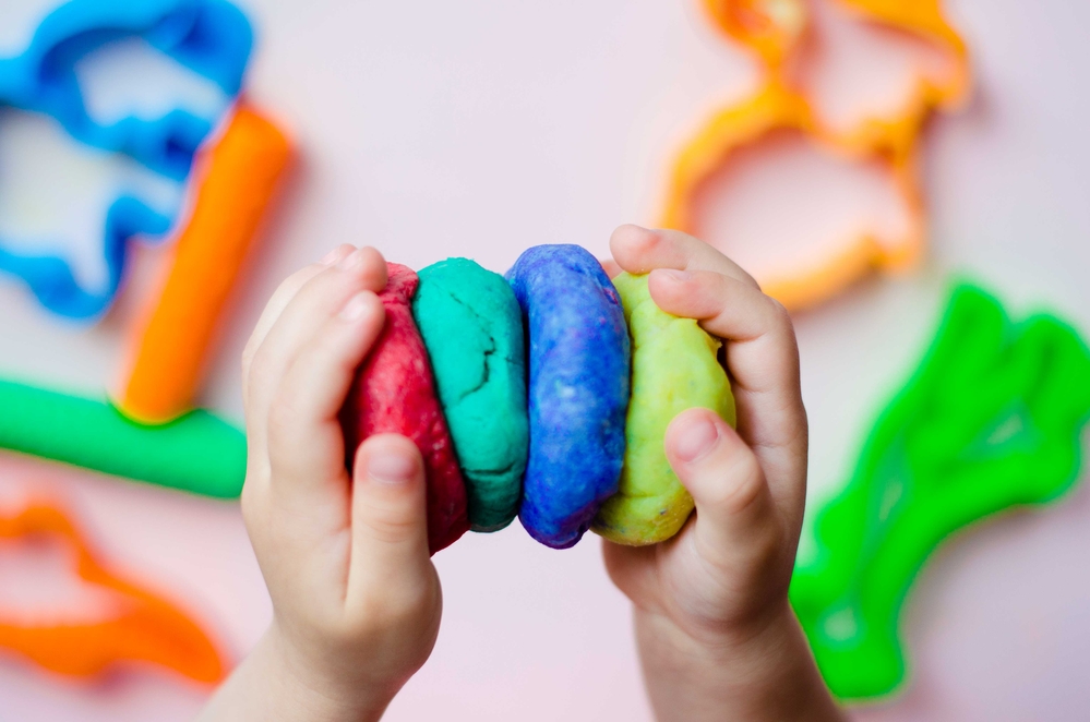 child playing with play dough