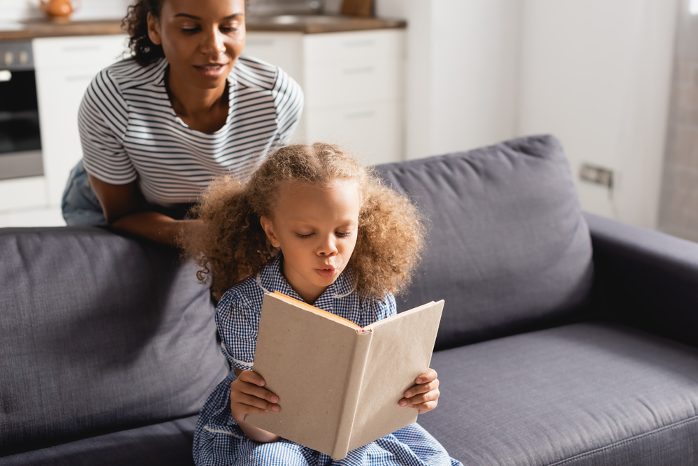 Parent helping child with reading