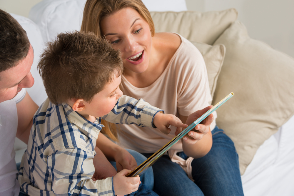 Mom reading aloud to son