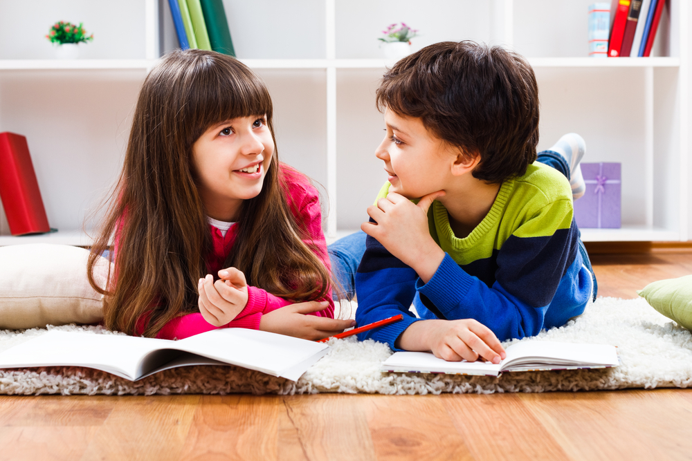 Two young kids working on pre-reading strategies