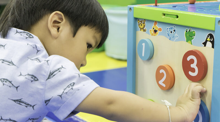 Young Boy is playing counting educational toy