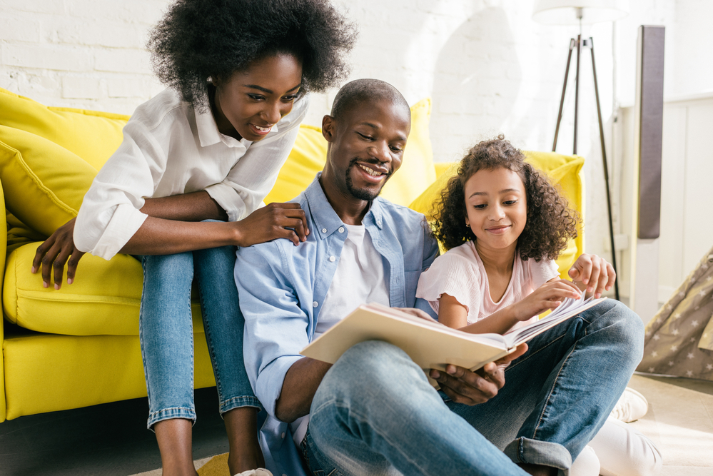 Dad with daughters helping with reading readiness