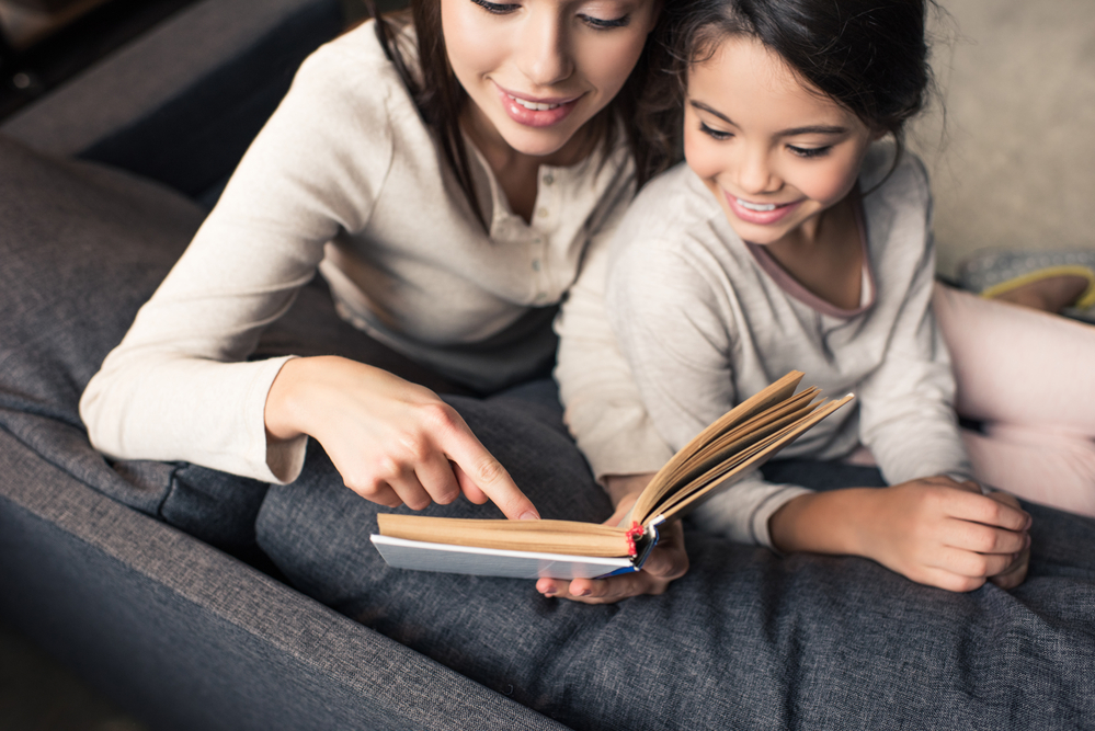 Parent and young child practicing 1st grade reading