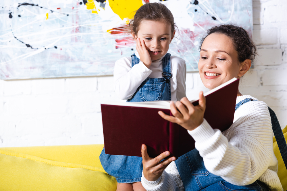 Parent with young child doing 1st grade reading 