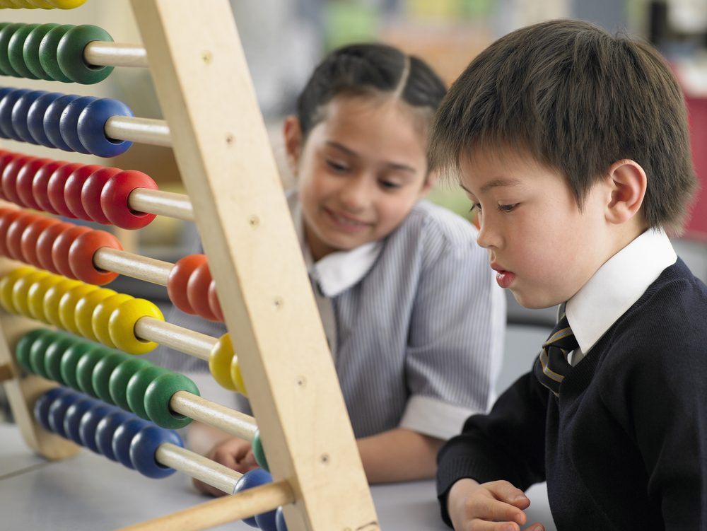 School kids Using an Abacus for kindergarten math