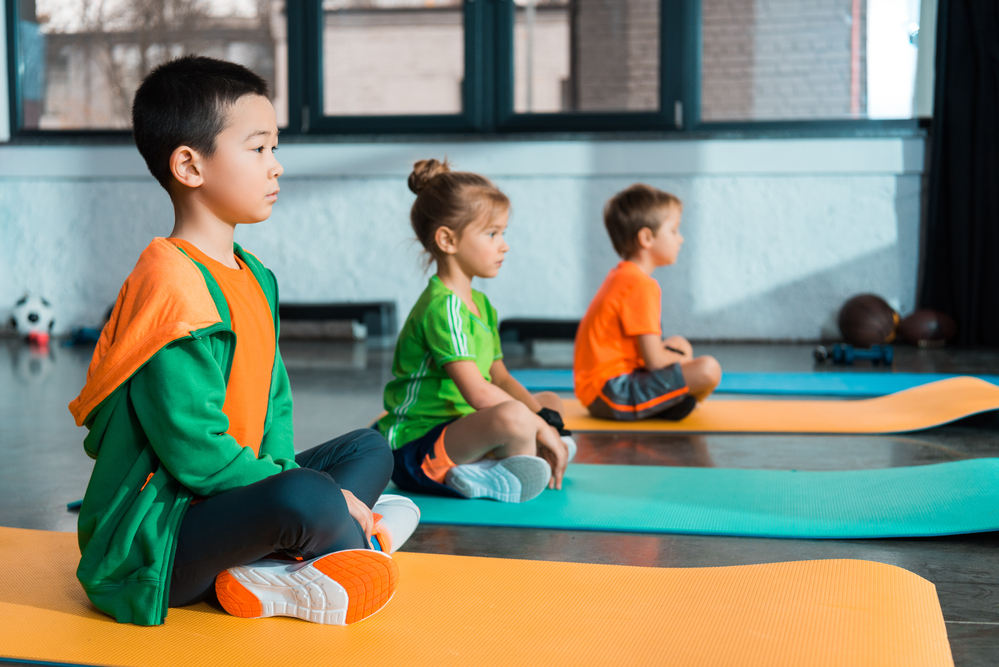 Group of kids learning meditation for kids