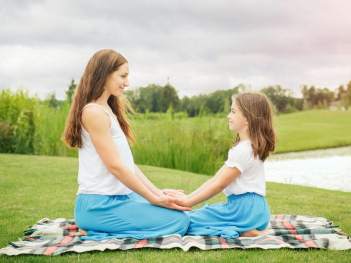 Mother with daughter teacher her meditation for kids