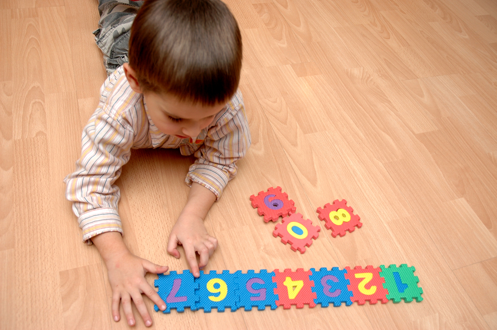 child playing with foam numbers