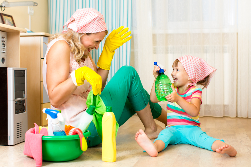 Mom cleaning with daughter to help teach her social skills for kids 