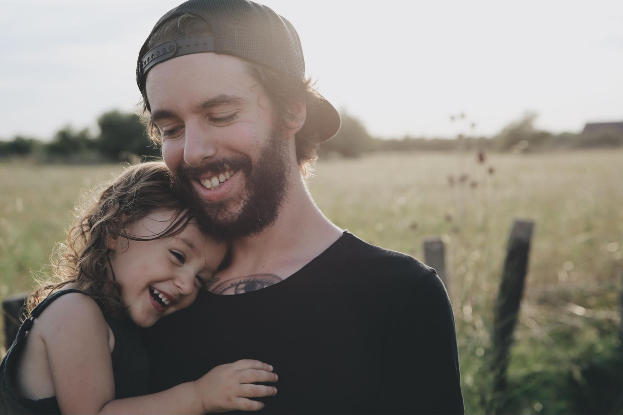 Dad holding daughter while showing her growth mindset for kids