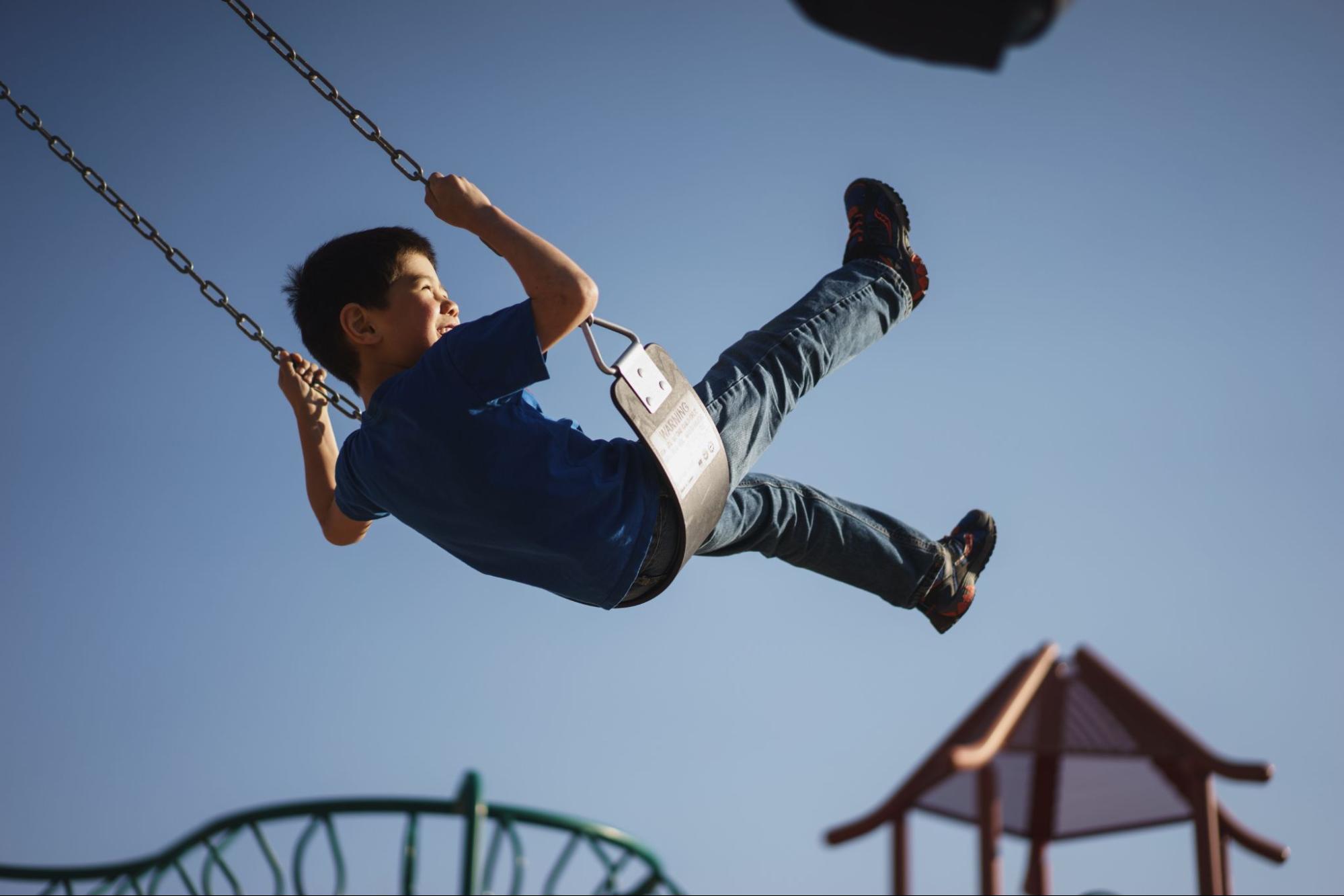 Kid on a swing in the air 