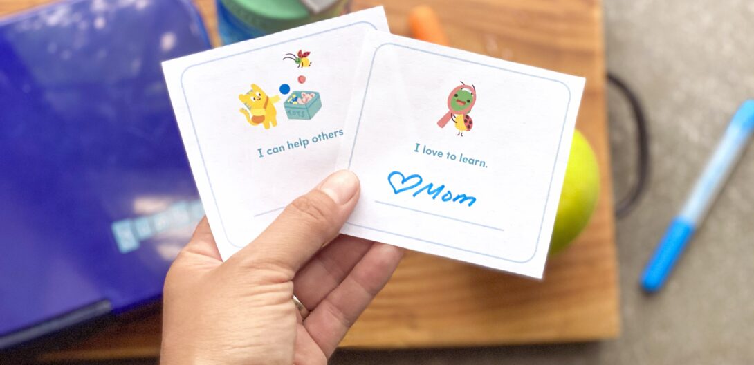free lunchbox printable held in a parent's hand over a child's lunch
