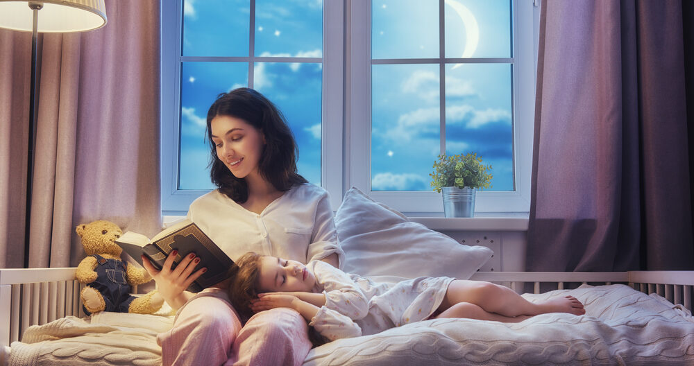 mother reading a book to daughter during bedtime routine