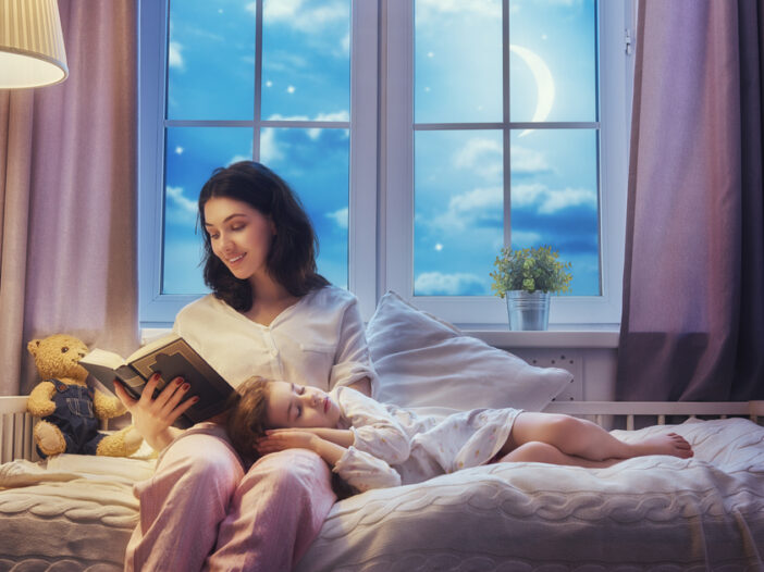 mother reading a book to daughter during bedtime routine