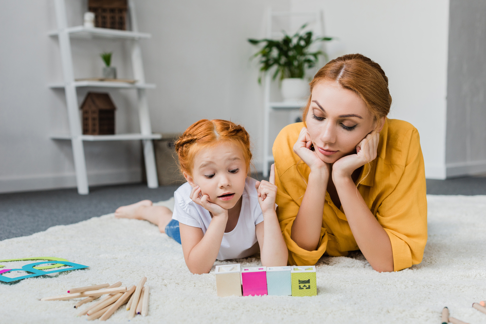 Mom playing with daughter teaching her shapes for kids