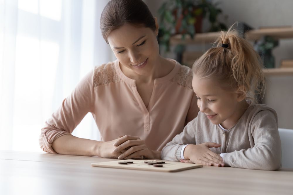 Mom playing a shape game with her daughter