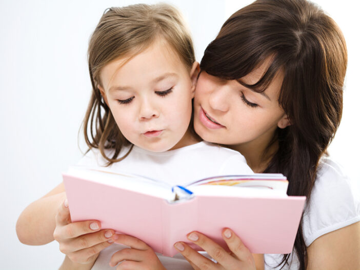Mother reading and teaching verbs for kids