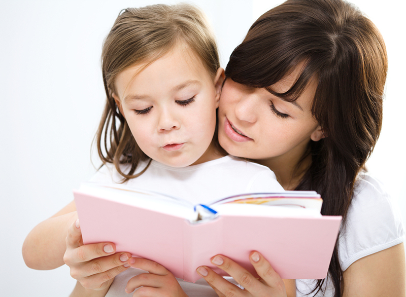 Mother reading and teaching verbs for kids
