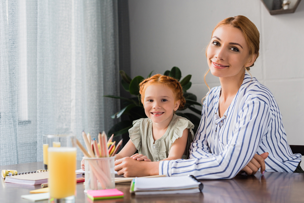 Mom with daughter helping her with school work