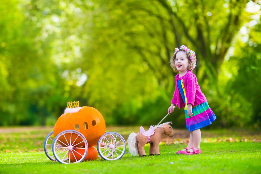 Young girl recreating Cinderella scene during dramatic play