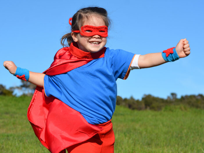 Girl dressed up as a super hero during dramatic play