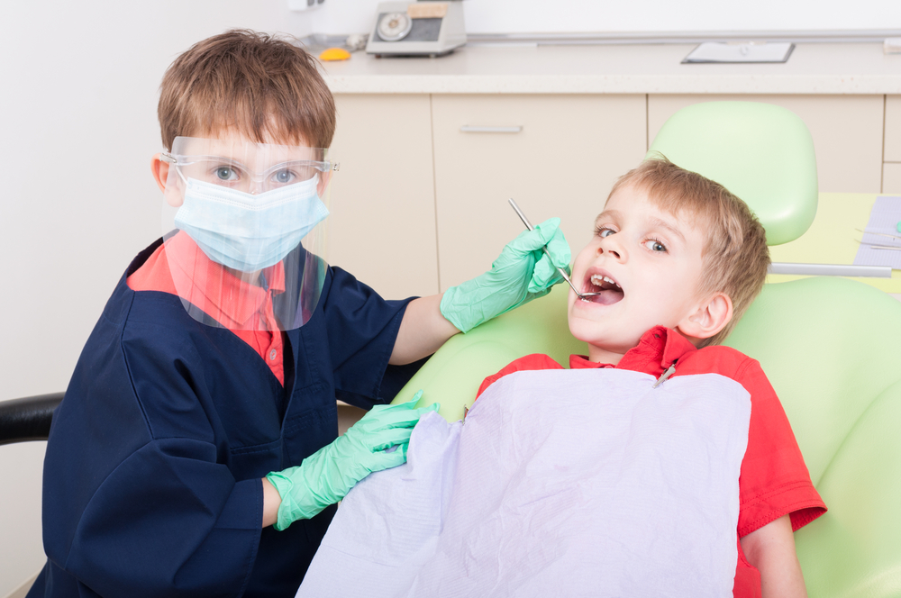 Kids doing dramatic play as a dentist and patient 