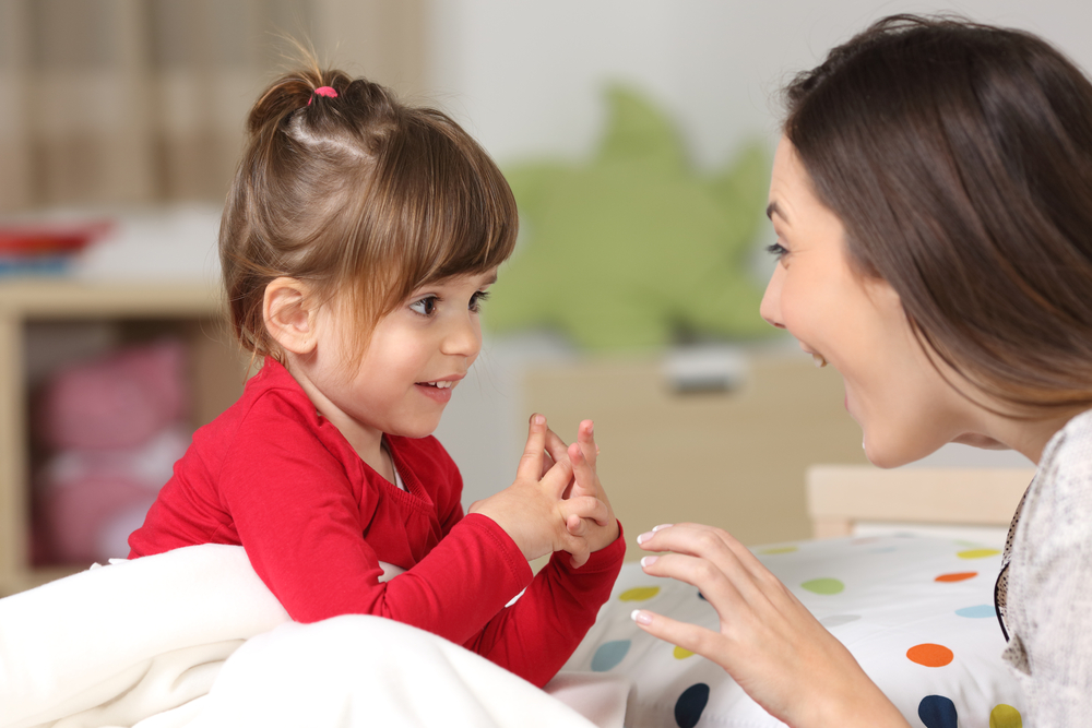 Mom working with child and teaching her sentences for kids 
