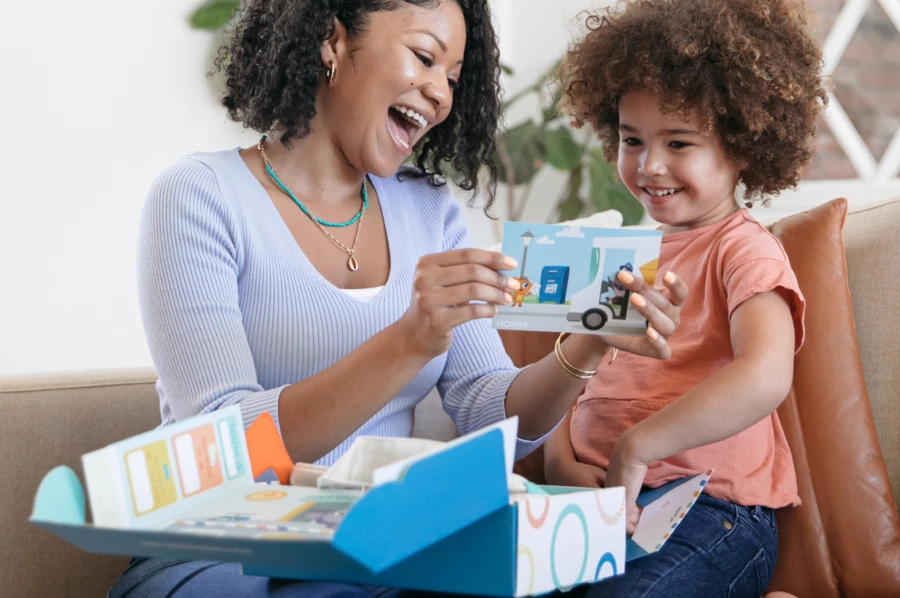 Mom opening up a box of creative activities for kids