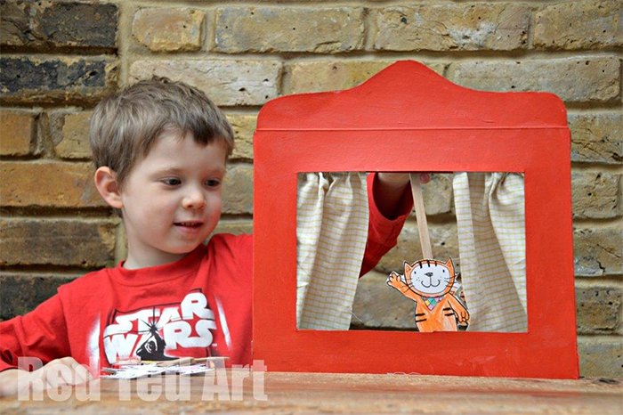 Young kid performing a puppet show