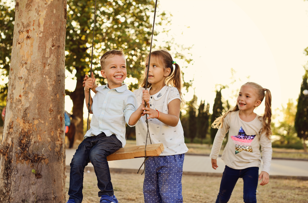 Group of children playing on a swing