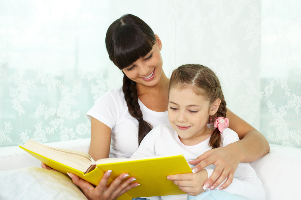 Mom doing kindergarten readiness
with daughter by reading