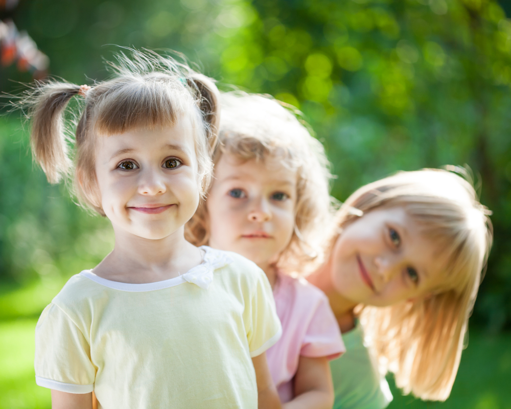 Three kids playing outside