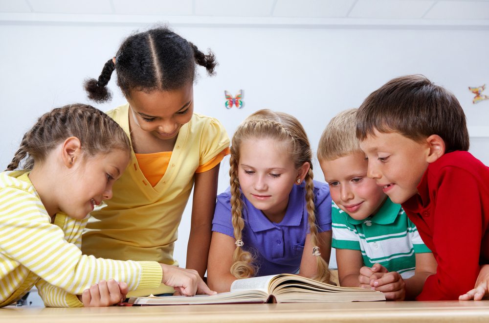 Group of kids reading a book