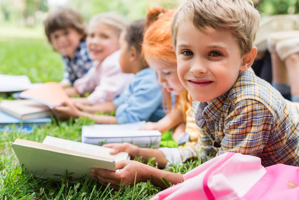 Kids reading outside together