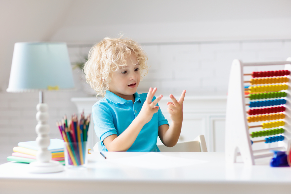 Young kid counting on his fingers