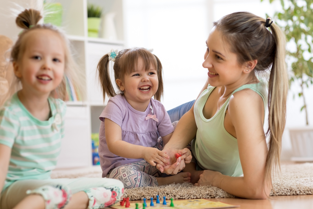 Mother and her children playing a board game