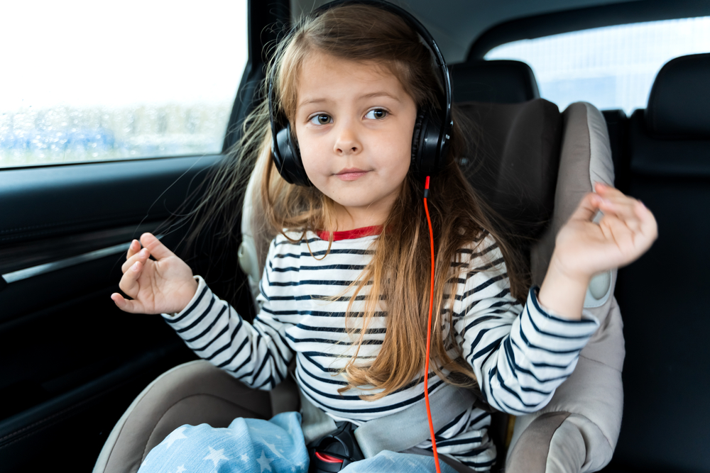 Daughter listening to music in the car