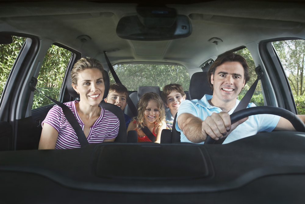 Family in the car ready with road trip games for kids
