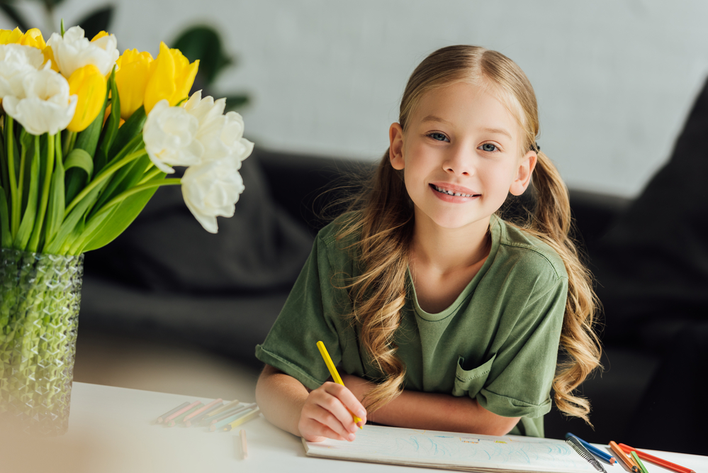 Young girl drawing to learn mindfulness for kids