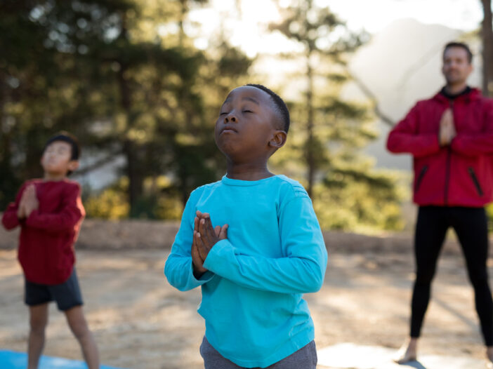Coach and kids practicing mindfulness for kids