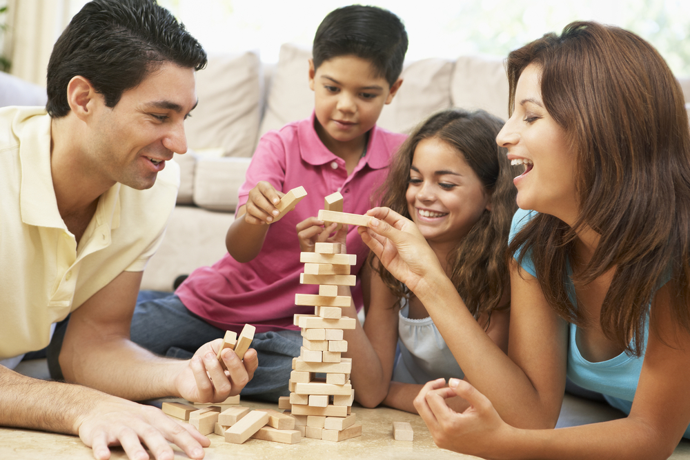 Family having a game night playing Jenga