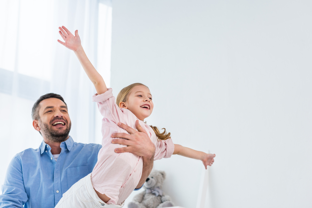 Dad playing fun educational games with daughter