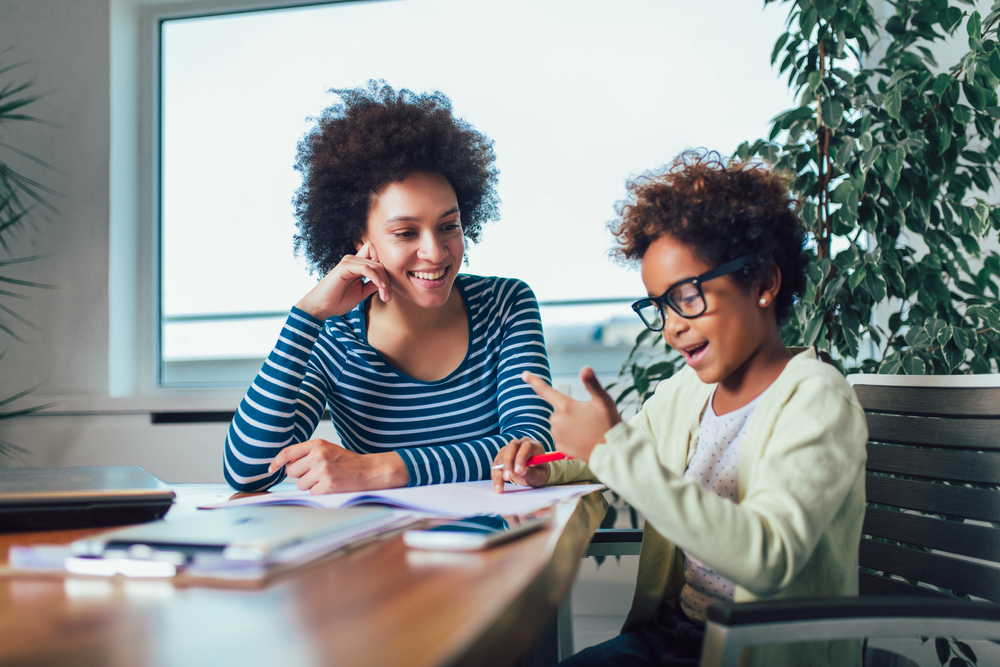 Mother and daughter doing homework learning to calculate