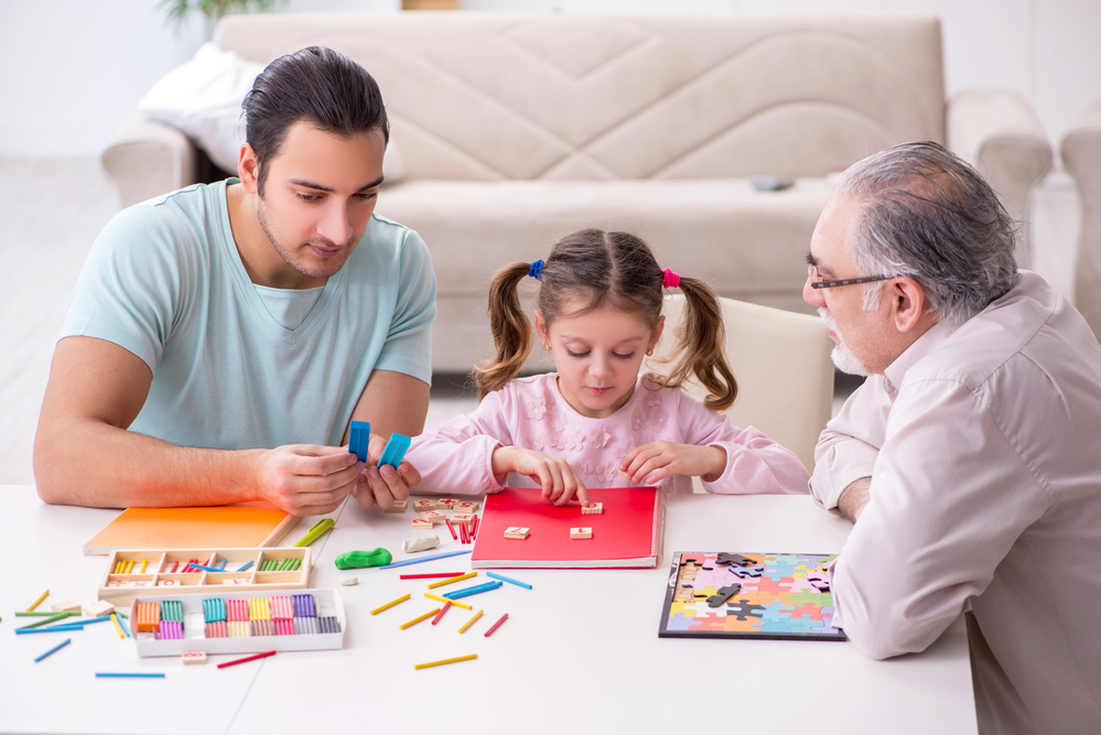 Three generations of family playing math games for kids