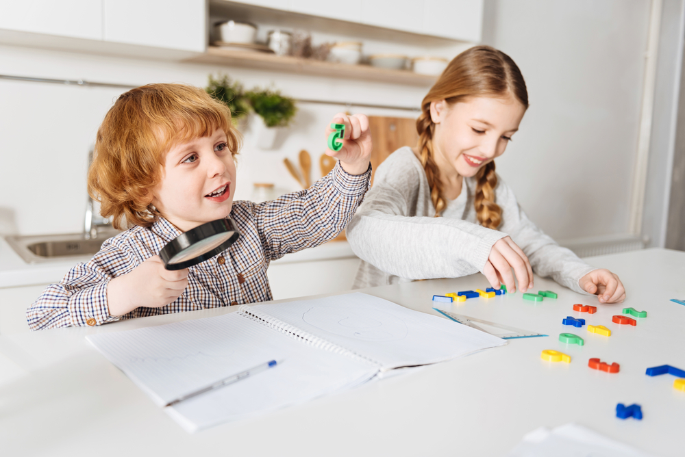 Two kids playing with plastic numbers to learn math