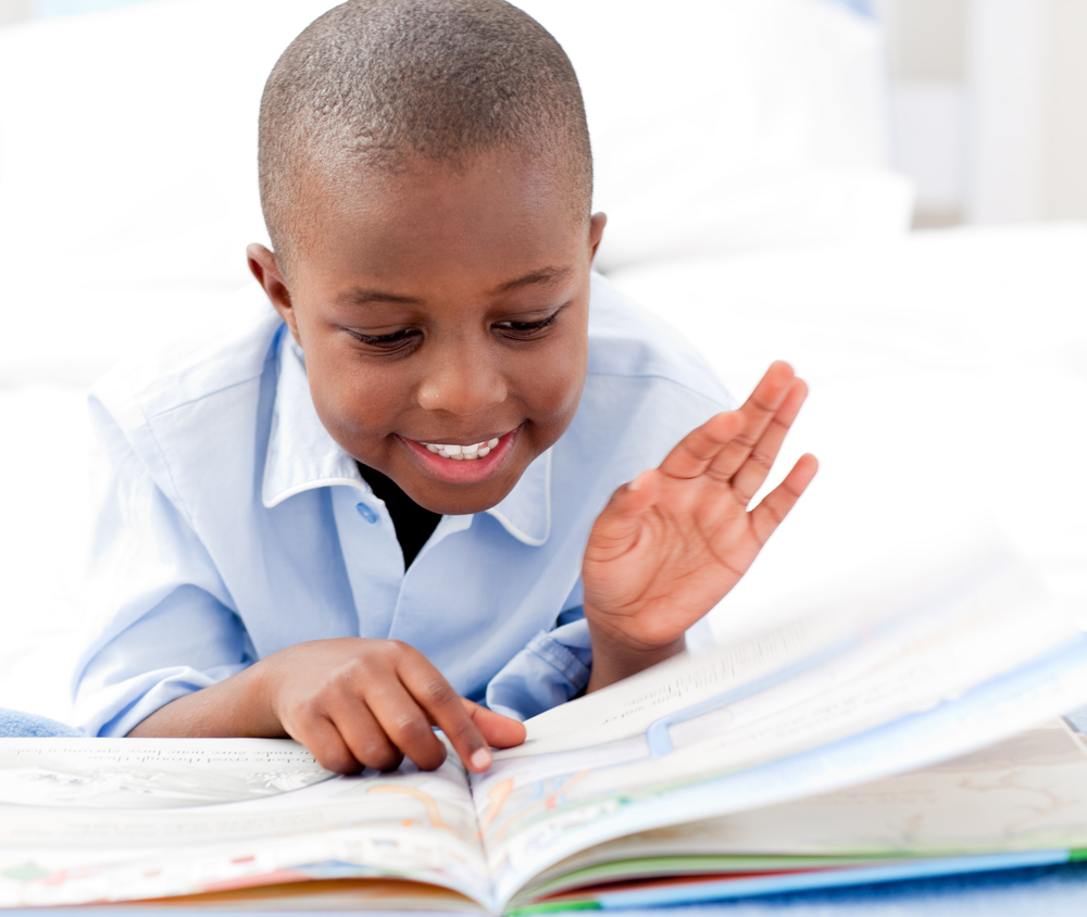 young boy reading a book
