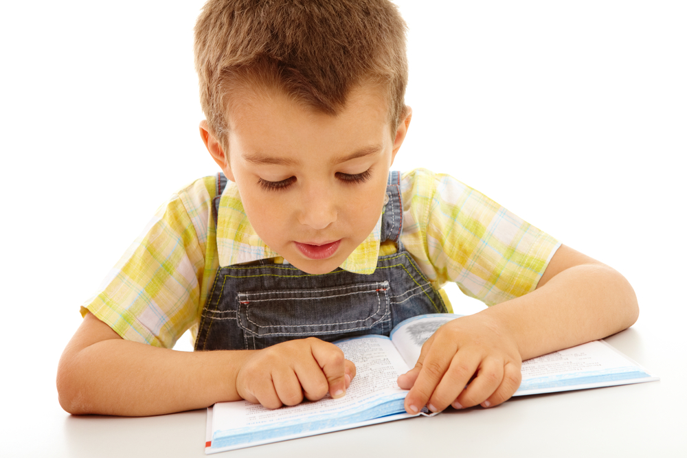 young boy working on reading fluency